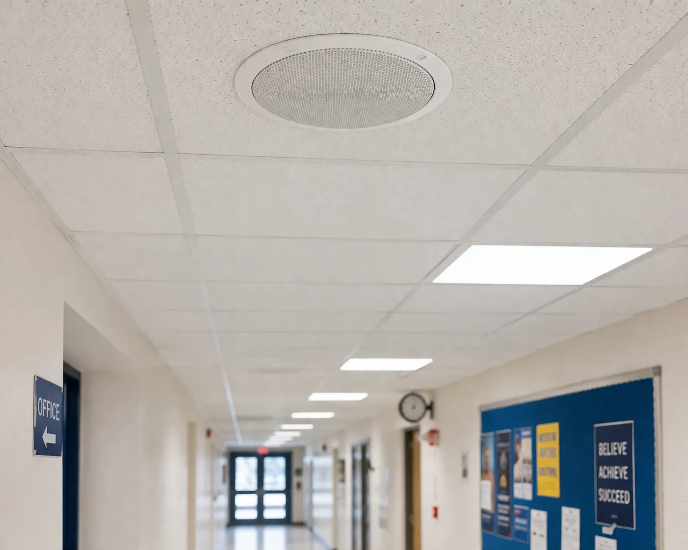 Ceiling paging speaker installed in school office corridor for clear indoor voice announcements